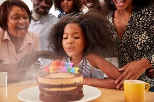 blowing out birthday cake candles