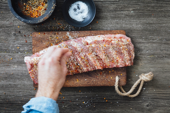 Ribs being seasoned