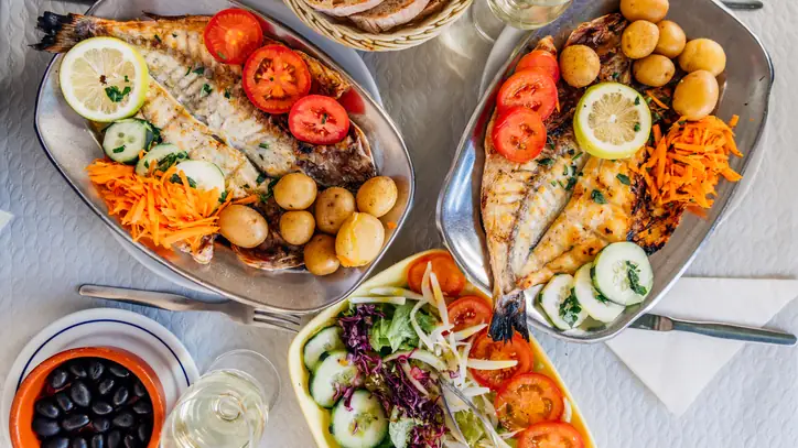 Portuguese food - grilled sea bream with potatoes and fresh salad