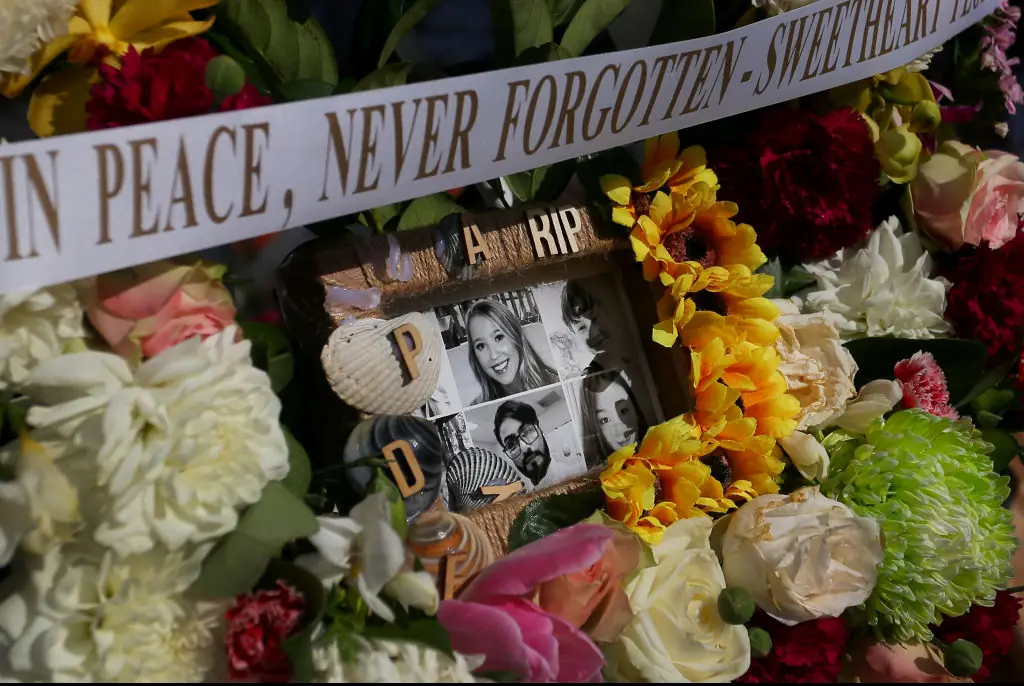 Flower tributes and condolence messages are seen at the edge of Westfield Bondi Junction. Credit: Lisa Maree Williams/Getty