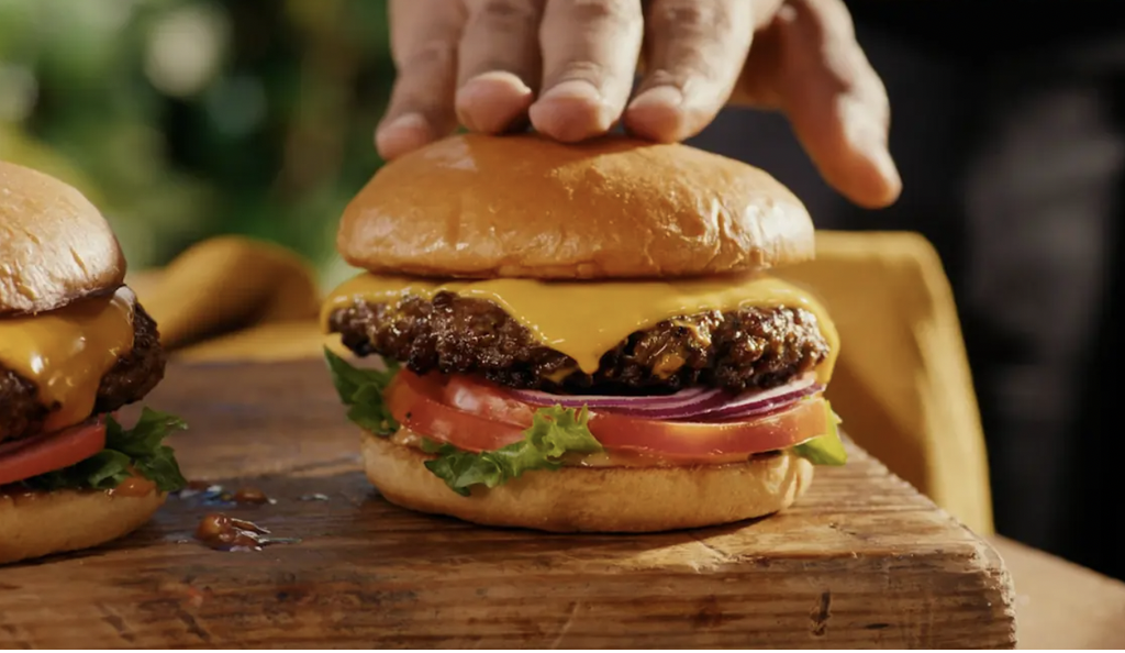 Daiya cheese advert suggests putting vegan cheese on beef burger