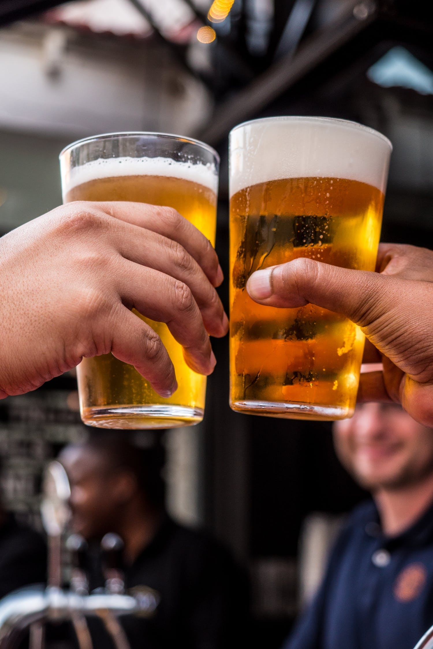 An image of two people drinking beers. 